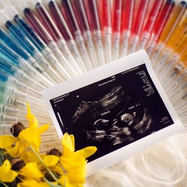 IVF needle and syringe rainbow pregnancy announcement infertility