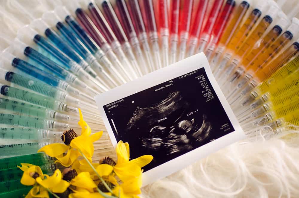 IVF needle and syringe rainbow pregnancy announcement infertility