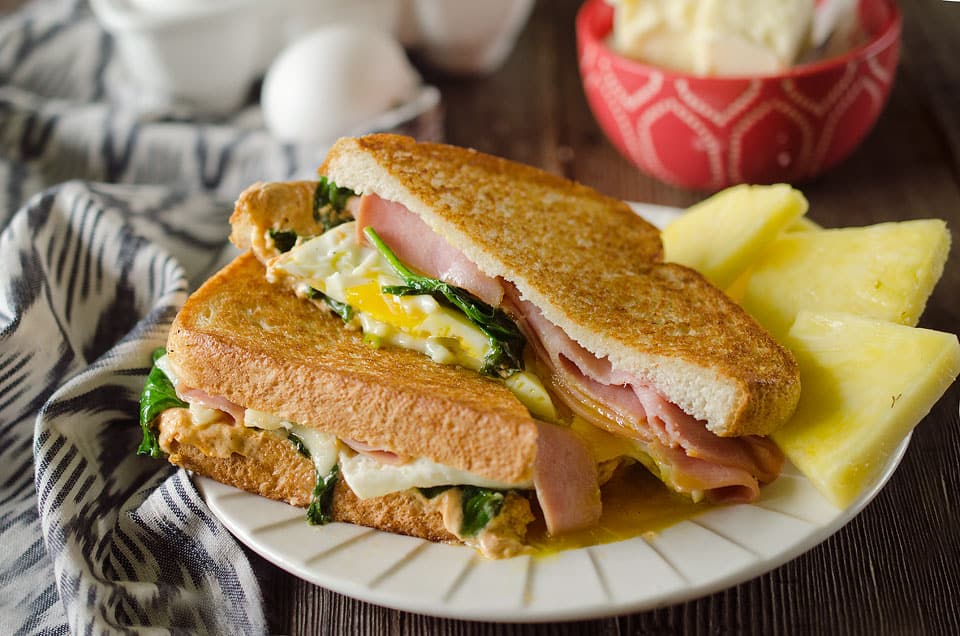 Spicy Ham & Egg Sandwich served with fresh fruit