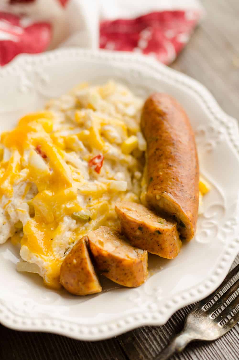 Cheesy Southwest Sausage & Hash Brown Casserole plated with sliced chicken sausage