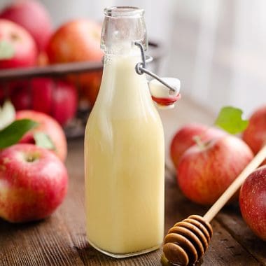 Light Apple Cider Vinaigrette bottle with apples