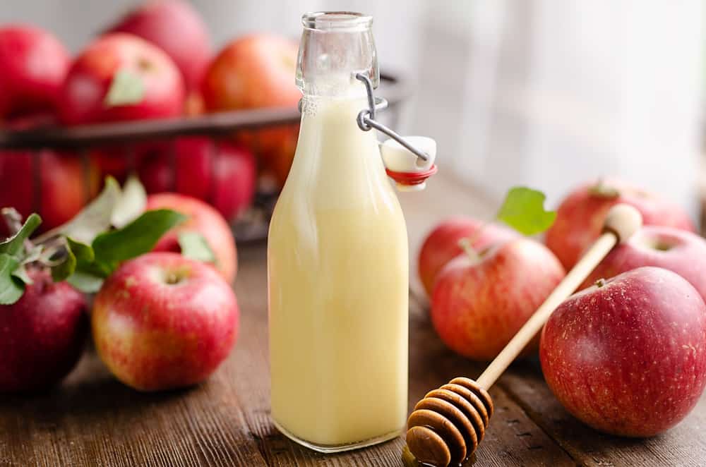 Light Apple Cider Vinaigrette bottle with apples