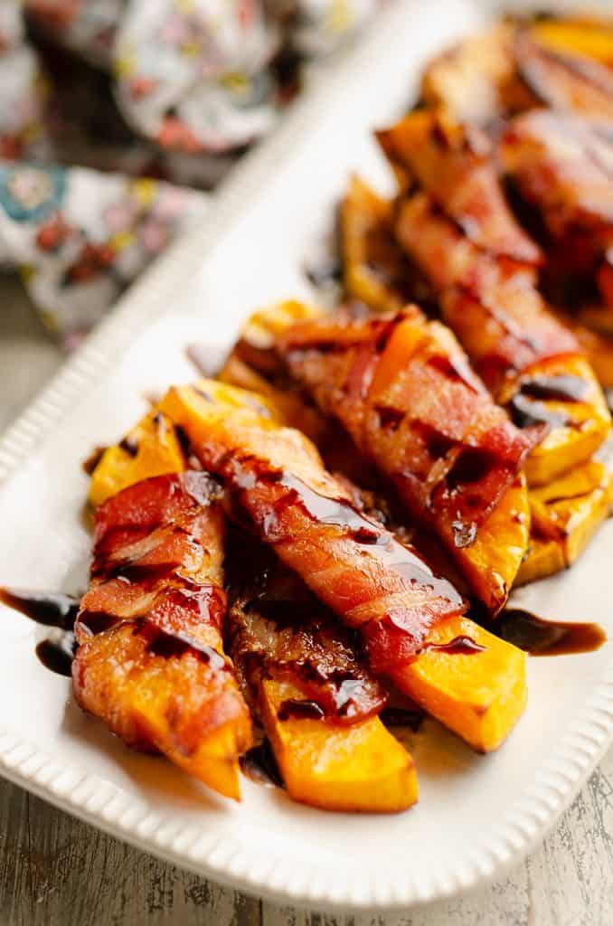 Balsamic Glazed Bacon Wrapped Squash spears served on platter