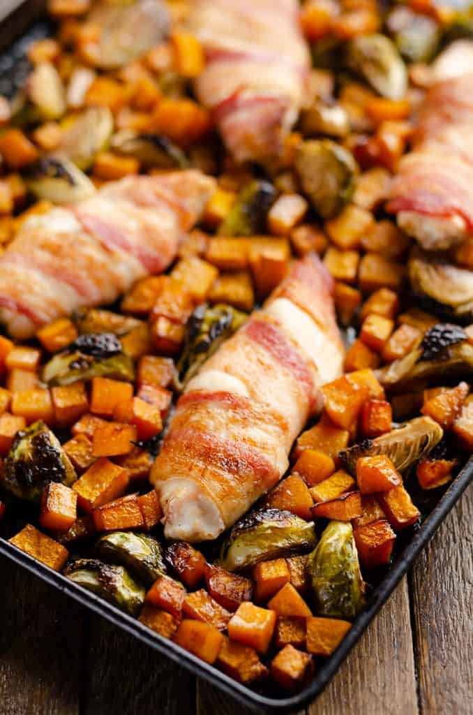 Bacon Wrapped Chicken Tenders on sheet pan with vegetables