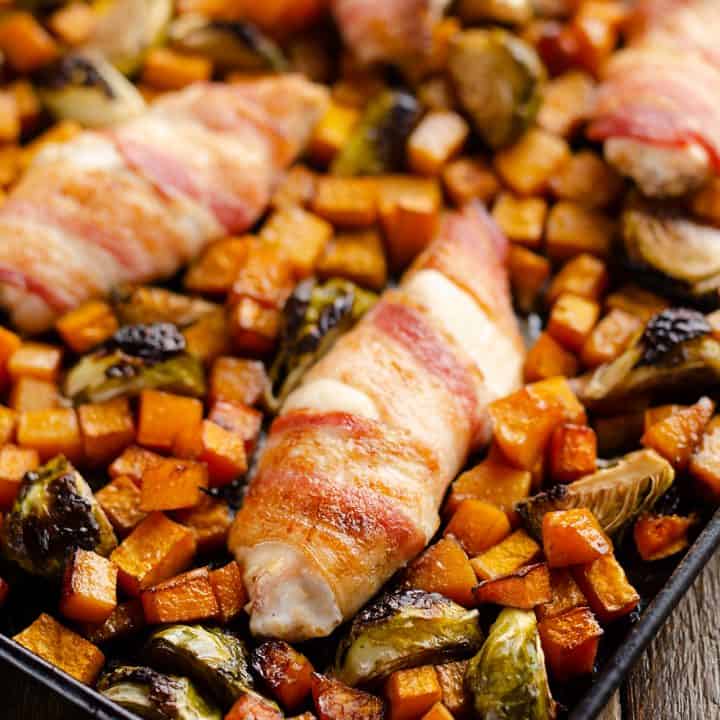 Bacon Wrapped Chicken Tenders on sheet pan with vegetables