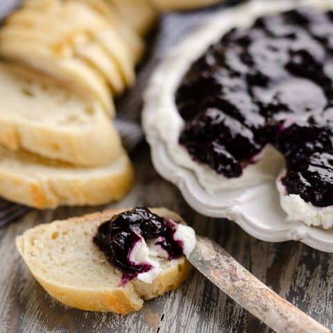 Blueberry Balsamic Goat Cheese Appetizer spread on bread with knife