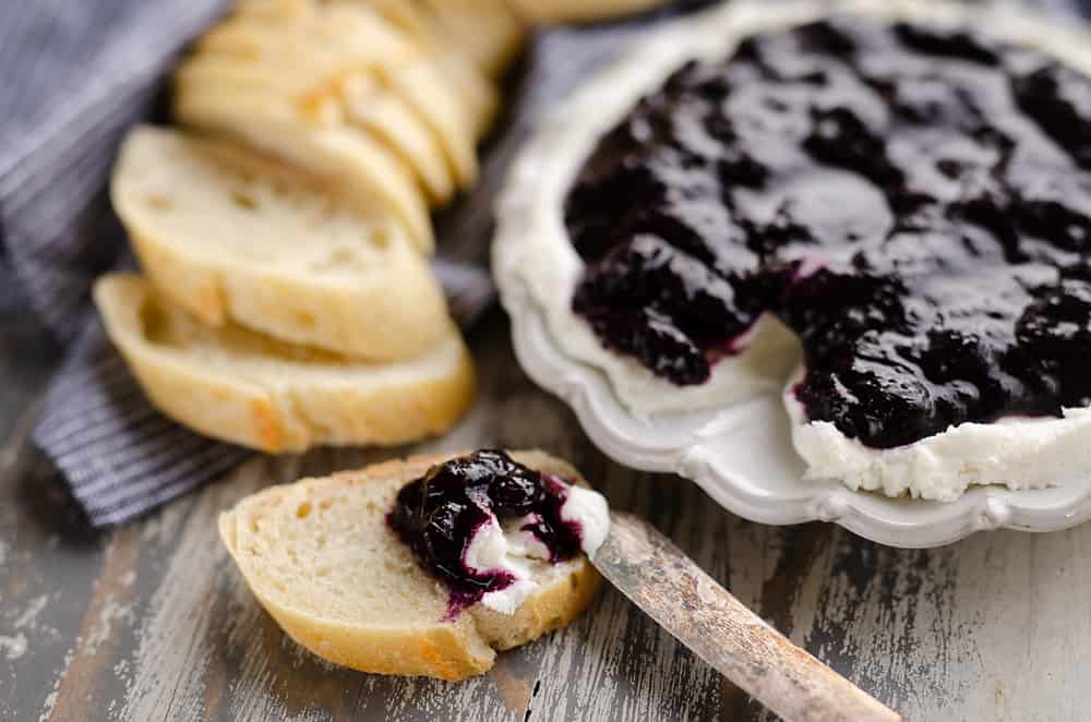 Blueberry Balsamic Goat Cheese Appetizer spread on bread with knife