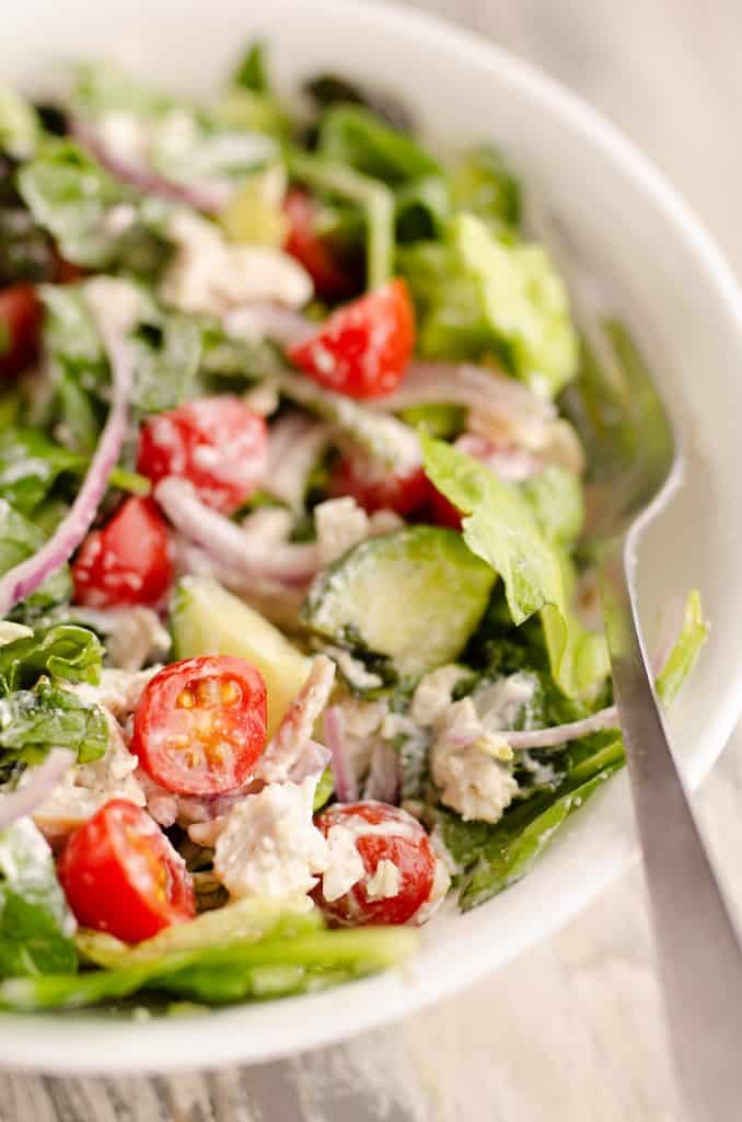 Creamy Greek Chicken Salad in a Jar tossed in bowl