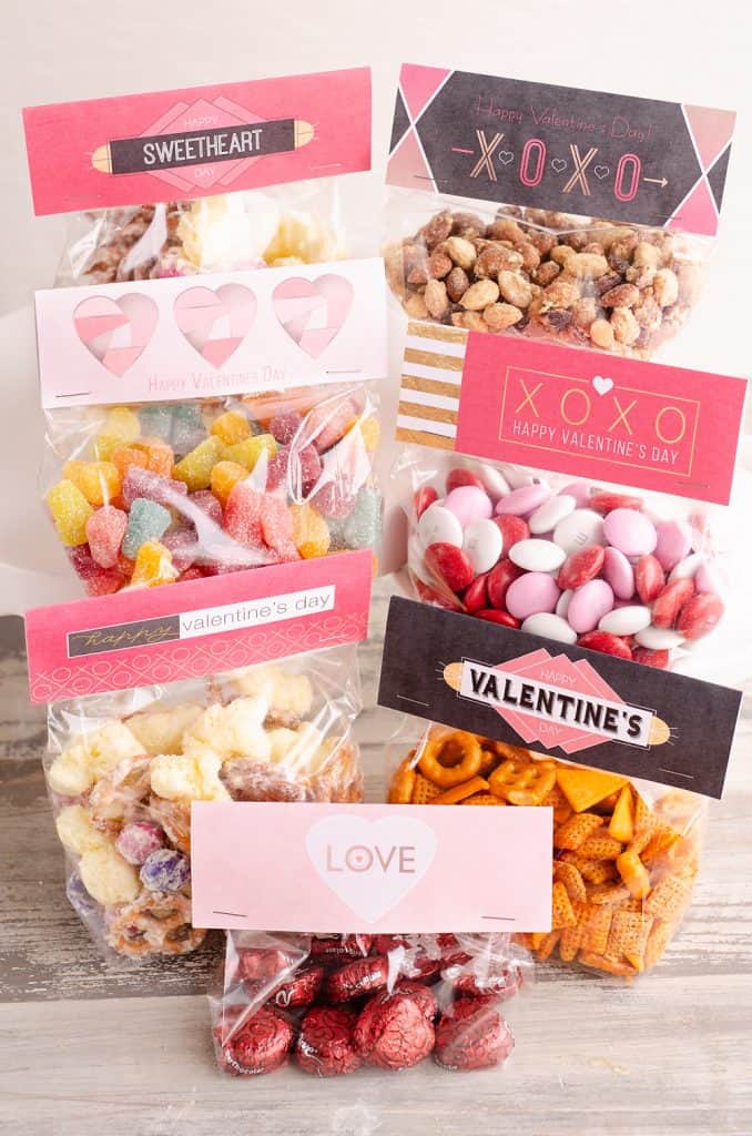 Free Printable Valentine Treat Bag Toppers in a variety of designs filled with candy and healthy snacks