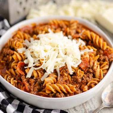 Pressure Cooker Light Pizza Noodle Casserole served with shredded cheese