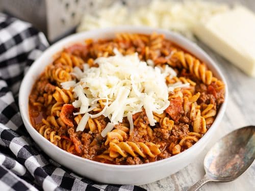 Pressure Cooker Light Pizza Noodle Casserole served with shredded cheese