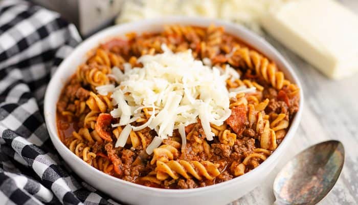 Pressure Cooker Light Pizza Noodle Casserole served with shredded cheese