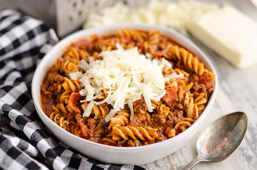 Pressure Cooker Light Pizza Noodle Casserole served with shredded cheese