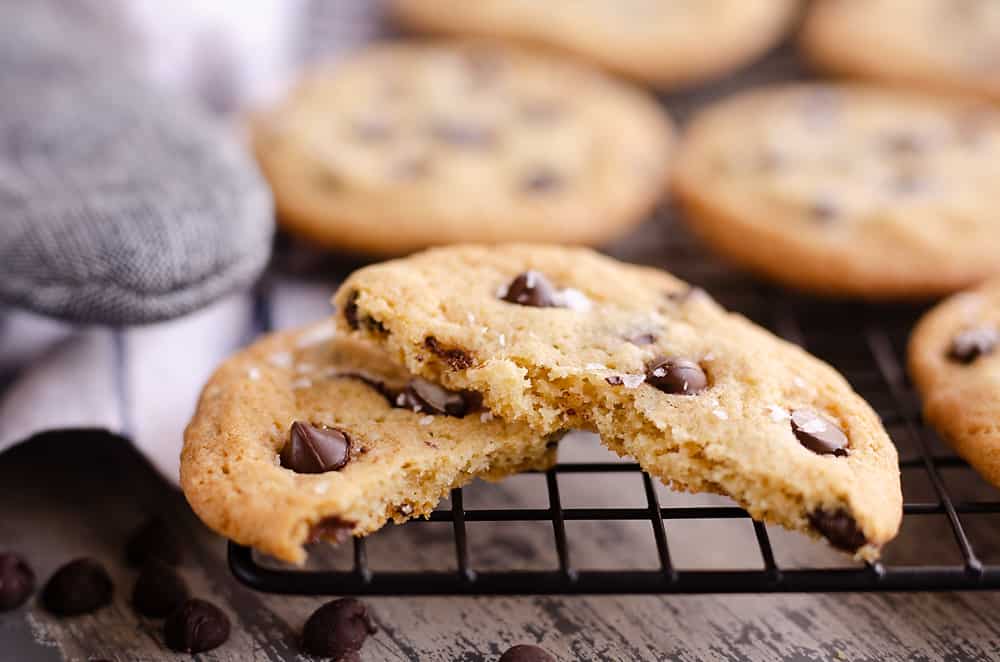 Best Chewy Chocolate Chip Cookie Recipe split in half on cooling rack