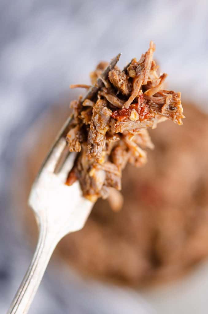 Chipotle Garlic Pressure Cooker Shredded Beef bite on fork