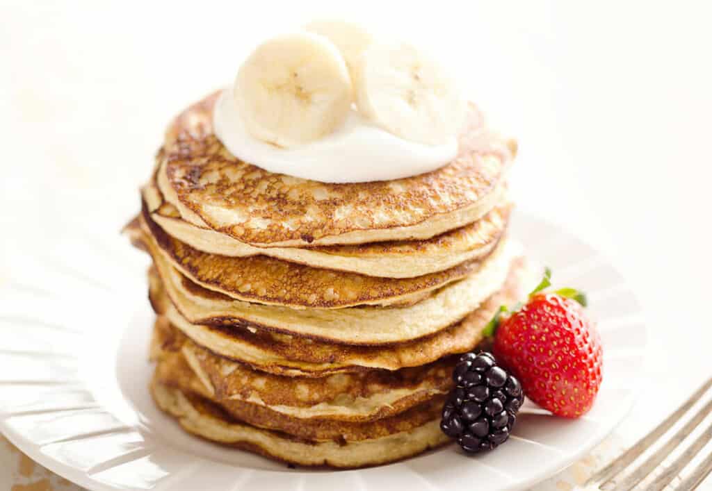 banana pancakes topped with yogurt and fruit