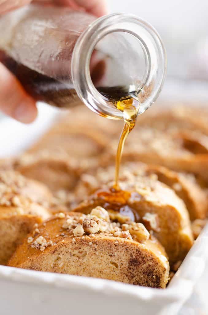 Cinnamon Pecan Overnight French Toast Casserole served with maple syrup poured over breakfast