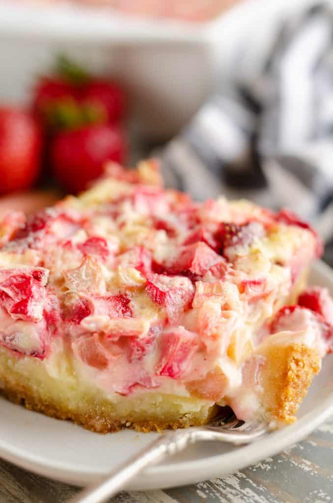 Strawberry Rhubarb Custard Dessert slice with bite on fork