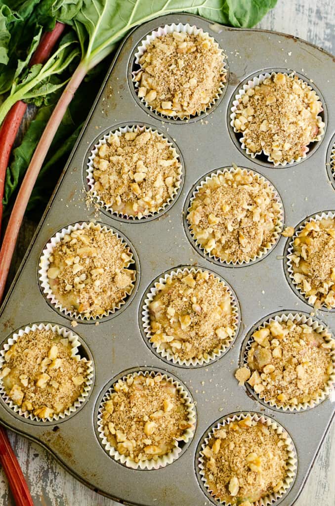 rhubarb muffins in muffin tin topped with walnut streusel