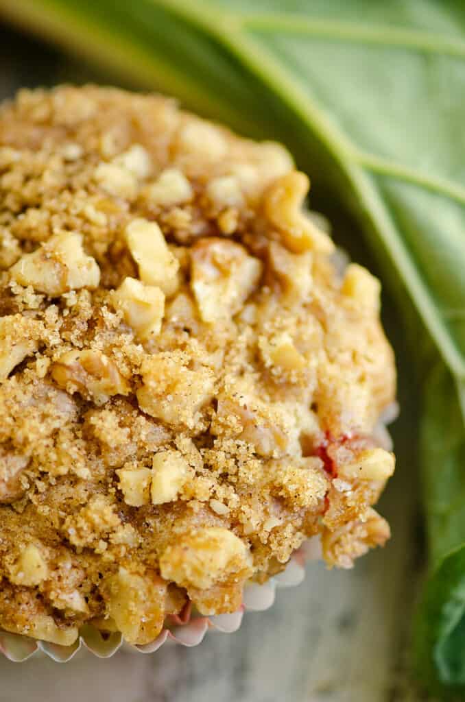 walnut and brown sugar streusel on the top of a rhubarb muffin