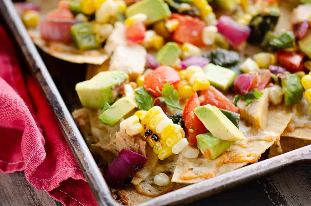 Avocado Corn Chicken Nachos cooked on sheet pan