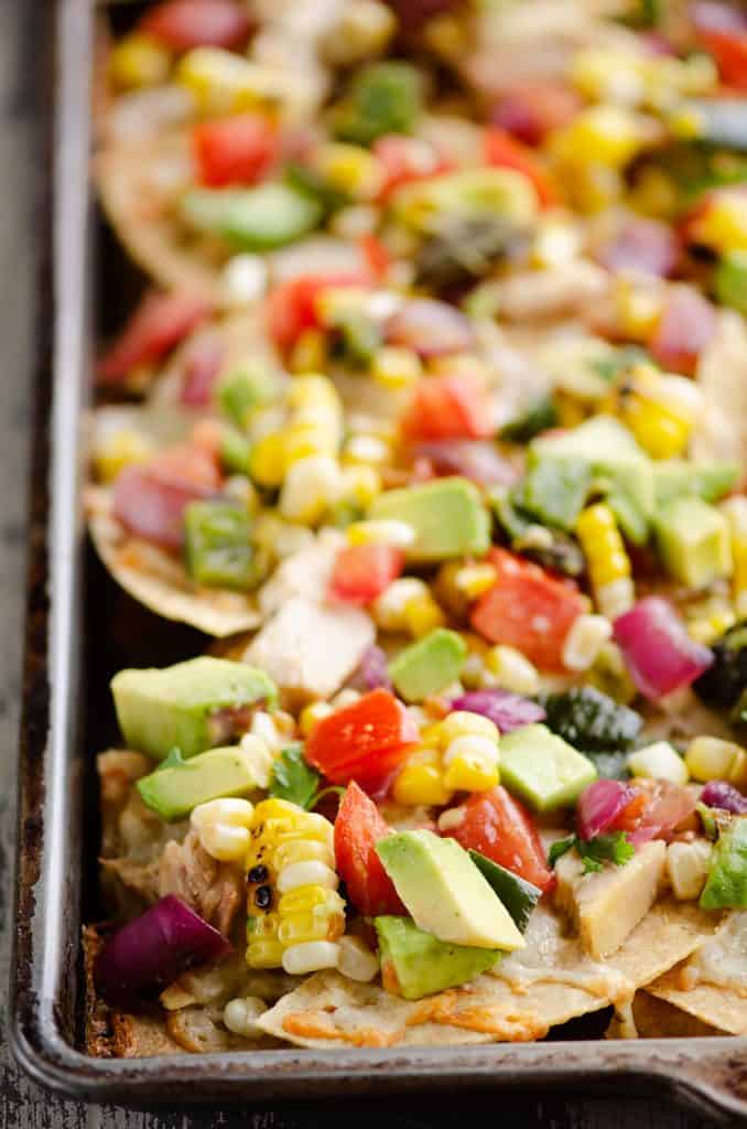 Avocado Corn Chicken Nachos on sheet pan