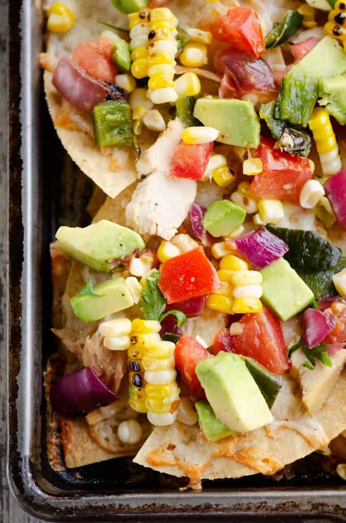 Avocado Corn Chicken Nachos on sheet pan