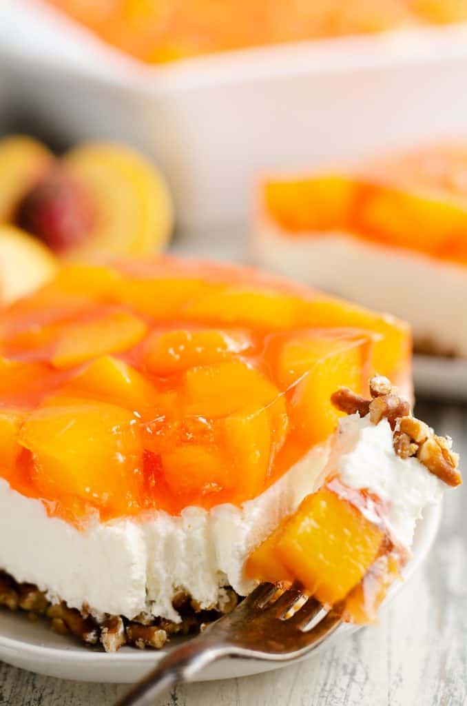 Peach Pretzel Salad Dessert with bite taken out of piece