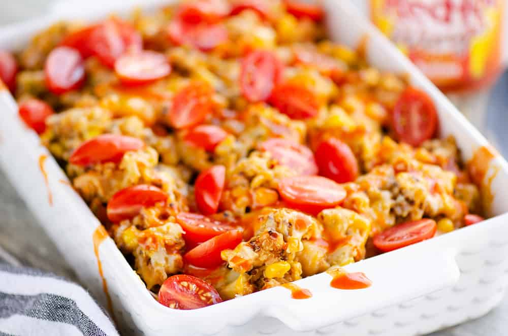 Pressure Cooker Buffalo Chicken Quinoa in casserole drizzled with sauce