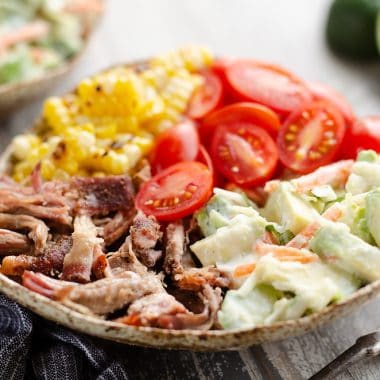 Pulled Pork Bowls with Avocado Slaw served on table