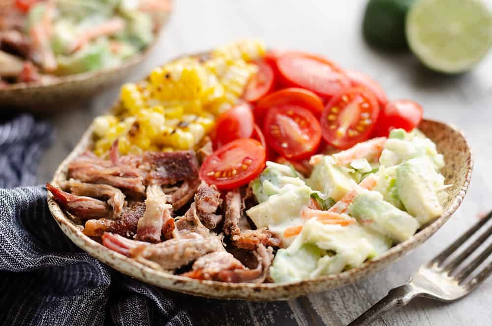 Pulled Pork Bowls with Avocado Slaw served on table