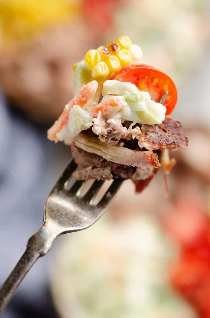 Pulled Pork Bowls with Avocado Slaw bite on a fork