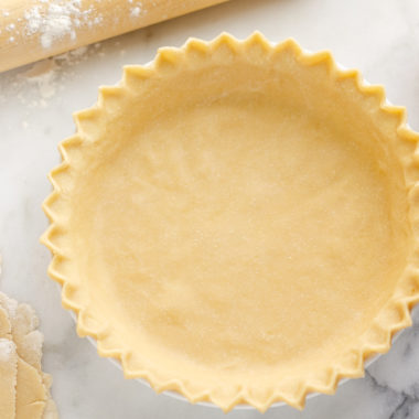 Flakey Pie Crust on marble table with rolling pin