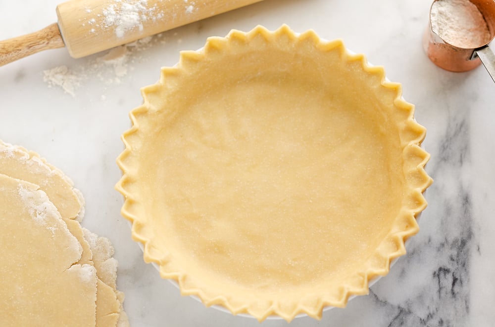 Flakey Pie Crust on marble table with rolling pin