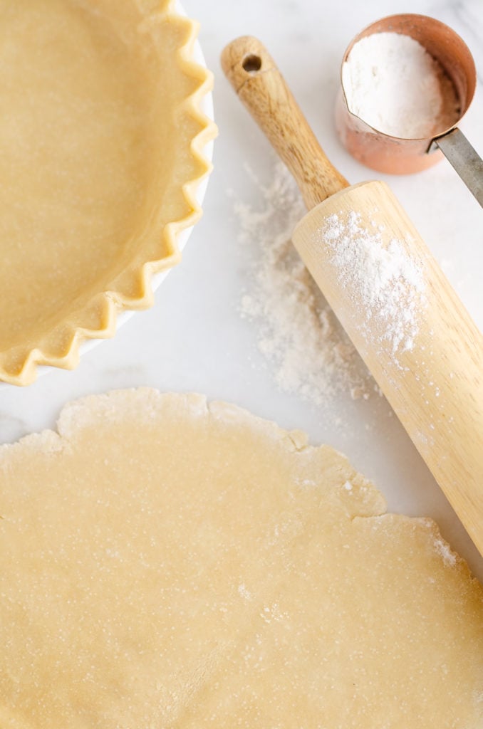 Flakey Pie Crust rolled out on marble counter with rolling pin