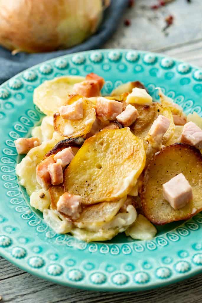 Scalloped Potatoes and Ham scooped on dinner plate