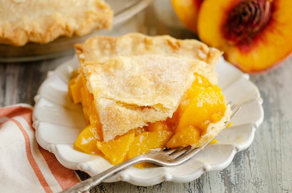 slice of peach pie on plate