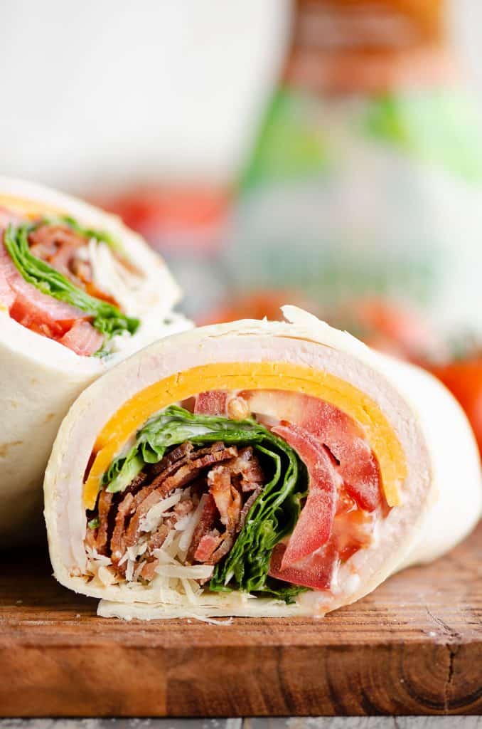 Turkey Bacon Parmesan Ranch Wrap sliced on cutting board