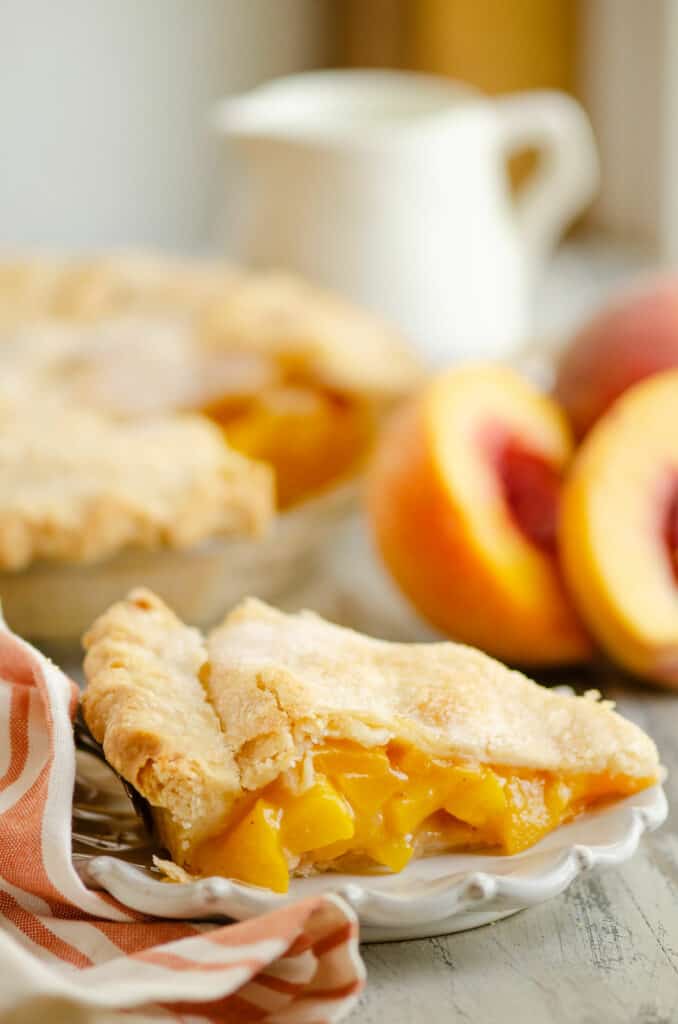 slice of peach pie on plate on table