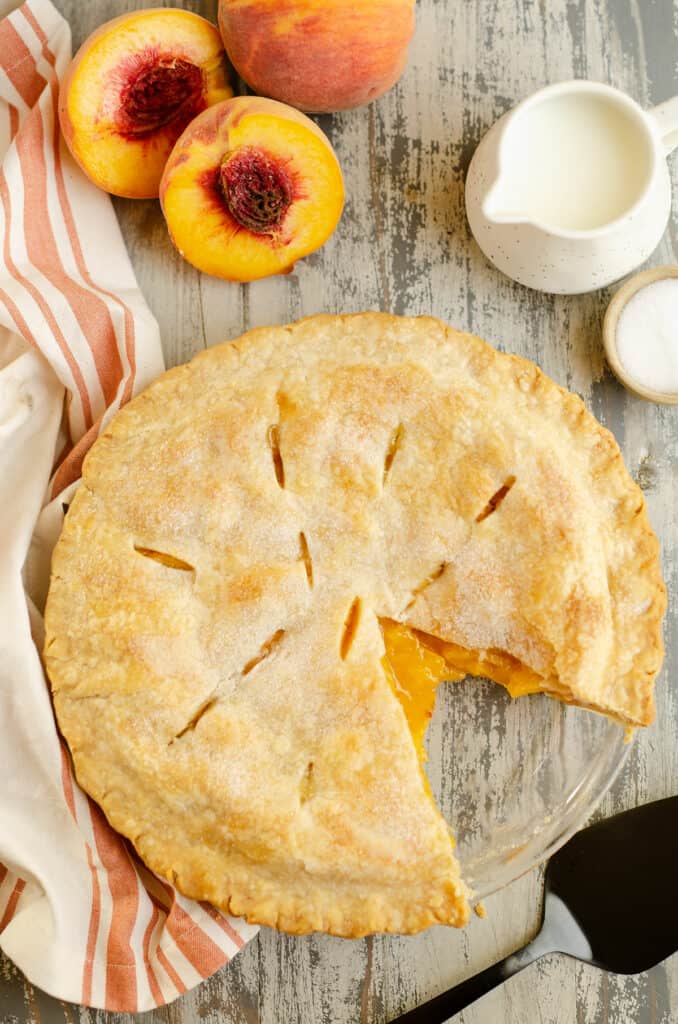 peach pie in pan with slice removed