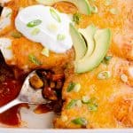 Black Bean & Squash Vegetarian Enchiladas scooped out of serving dish