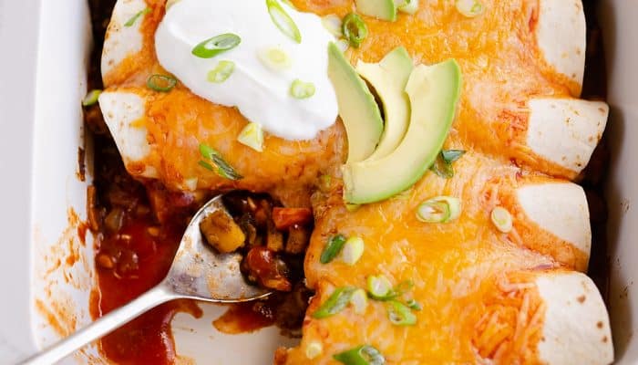 Black Bean & Squash Vegetarian Enchiladas scooped out of serving dish