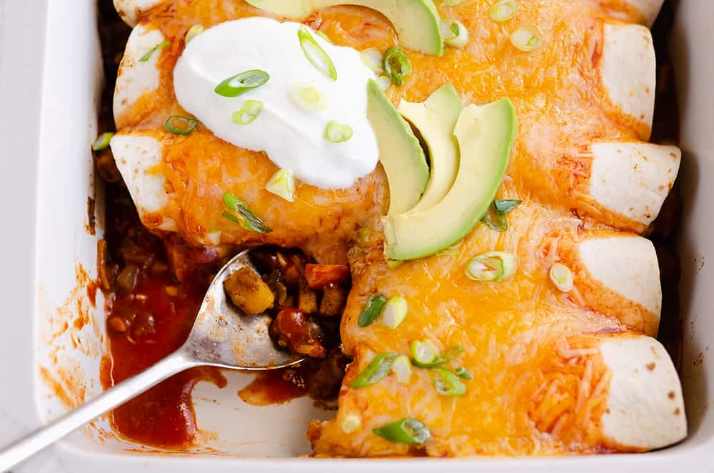 Black Bean & Squash Vegetarian Enchiladas scooped out of serving dish