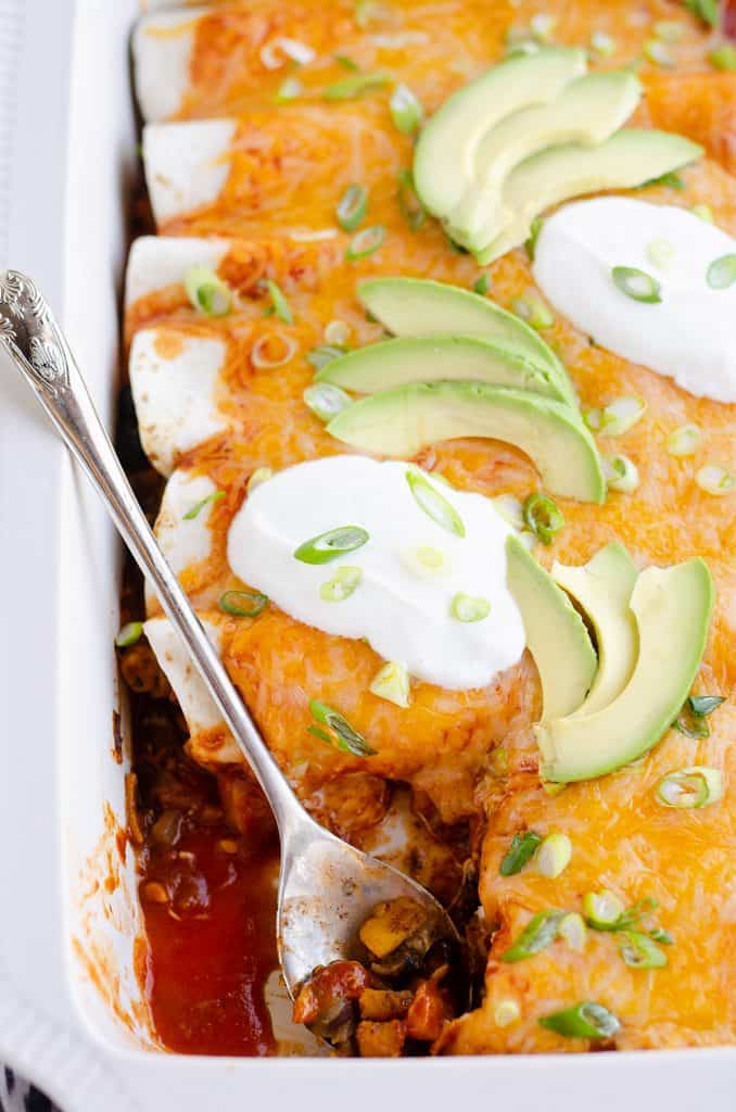 Black Bean & Squash Vegetarian Enchiladas scooped out of pan