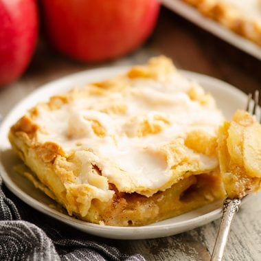 Glazed Apple Pie Bars on plate with fork full of apples