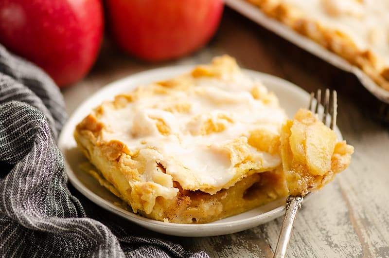 Glazed Apple Pie Bars on plate with fork full of apples