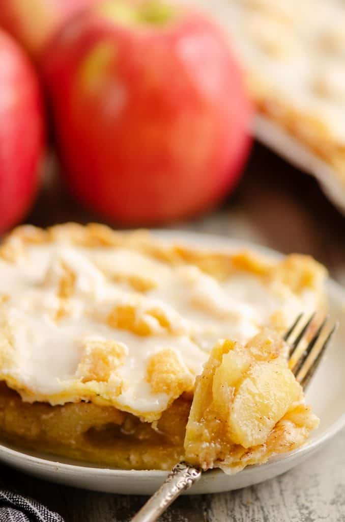 Glazed Apple Pie Bars on plate wiht bite on fork