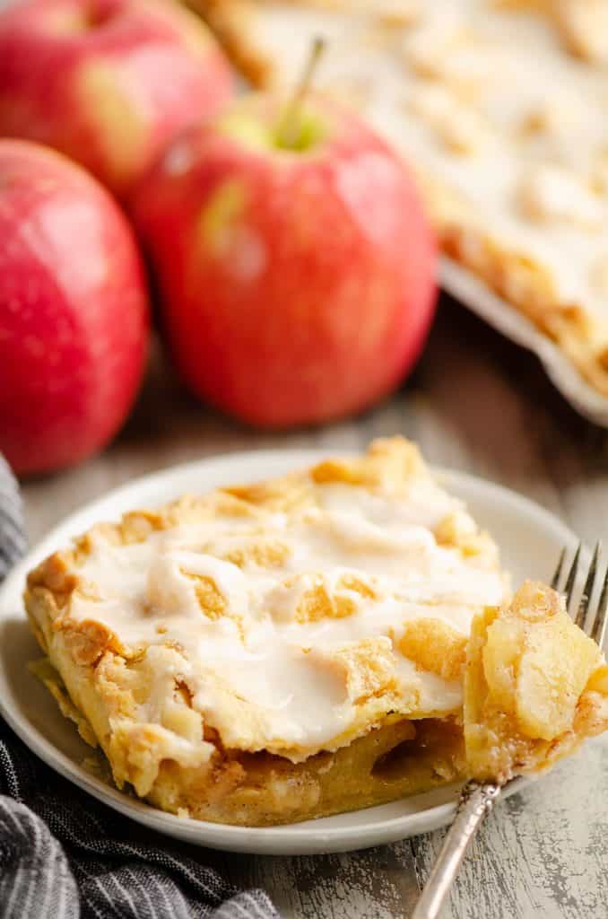 Glazed Apple Pie Bar on plate with bite on fork