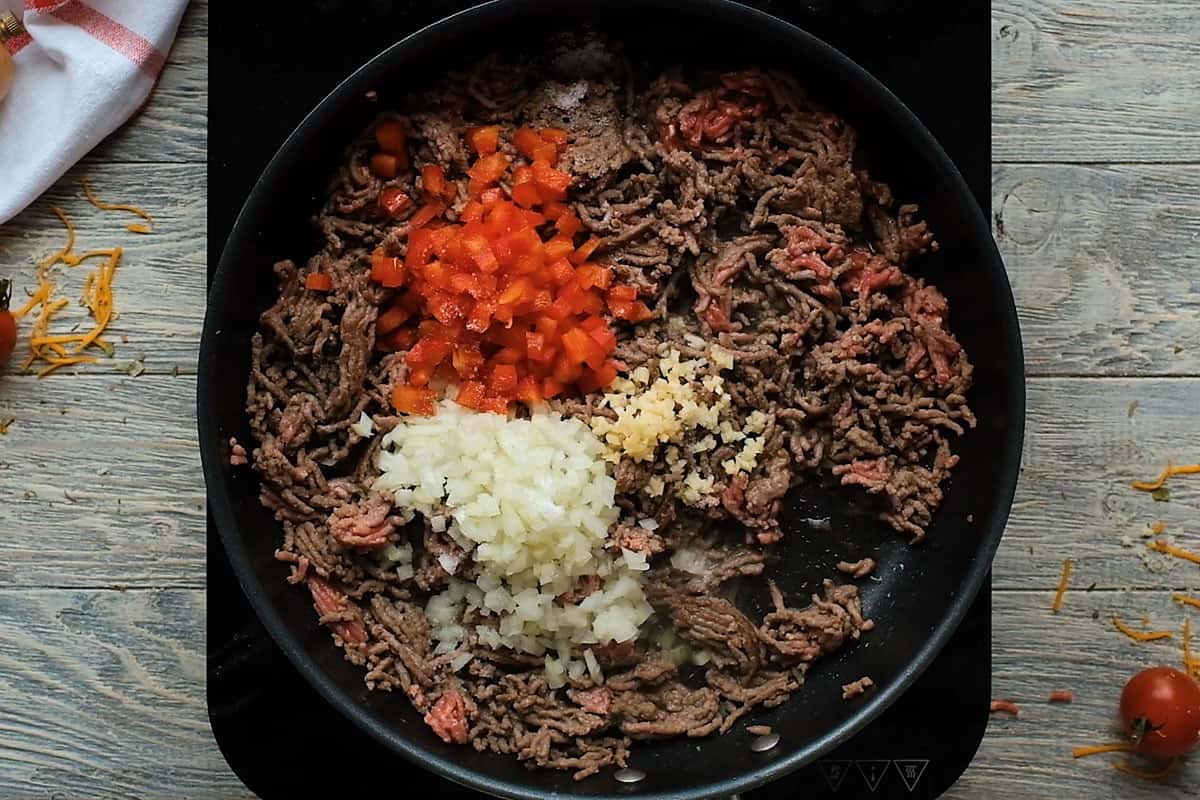 hamburger, bell peppers, onion and garlic in skillet