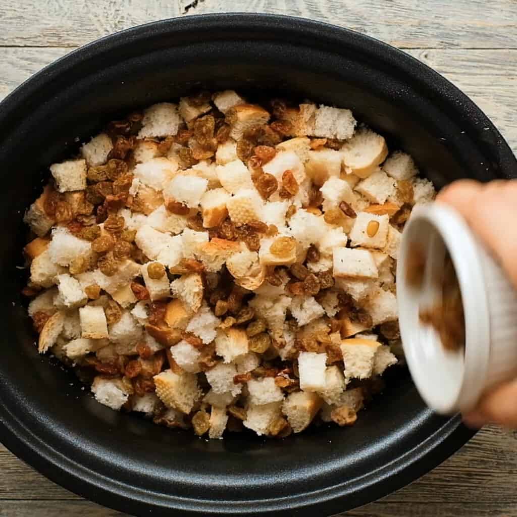 golden raisins sprinkled over stuffing in crock pot